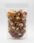 Assorted nuts and seeds in a clear plastic bag on a white background